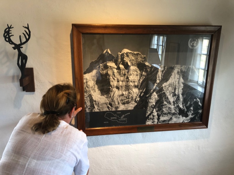 A woman next to a mountain photograph
