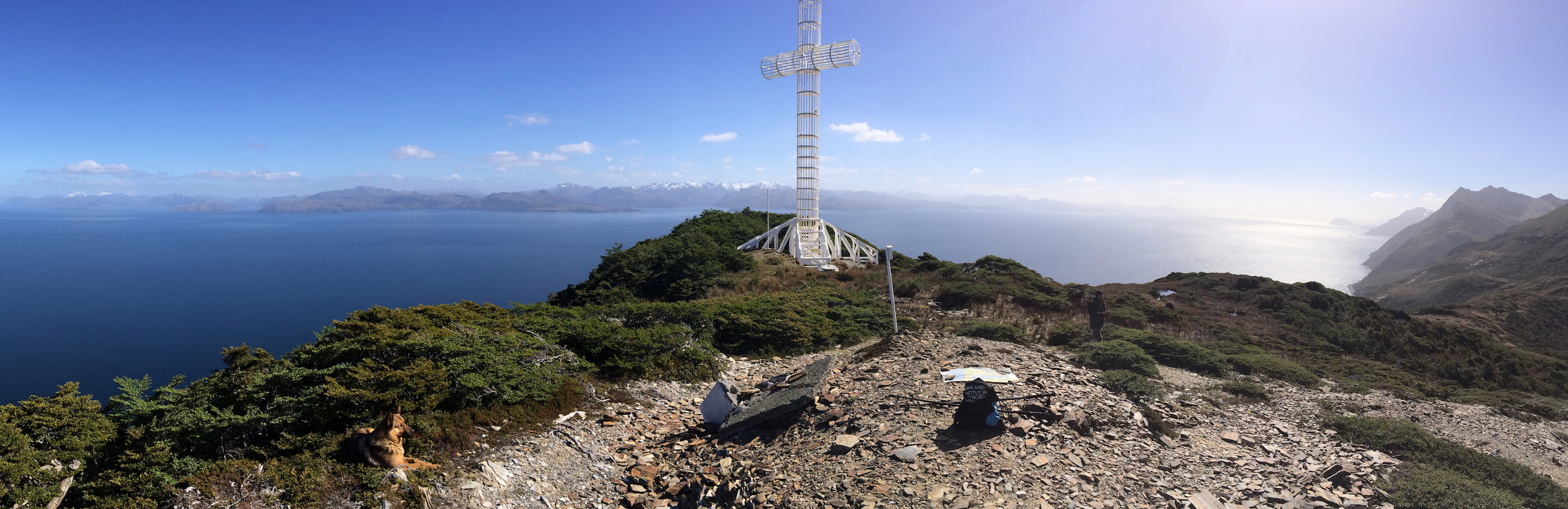 Photograph showing a white metal cross overlooking the sea